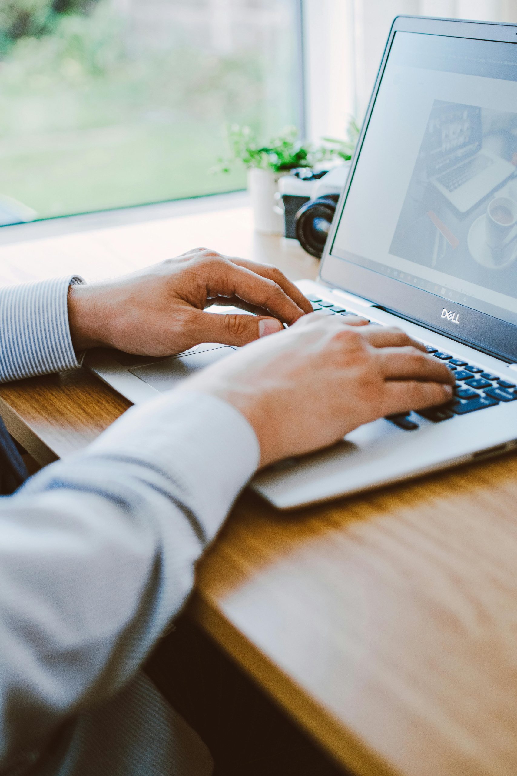 a person typing on a laptop